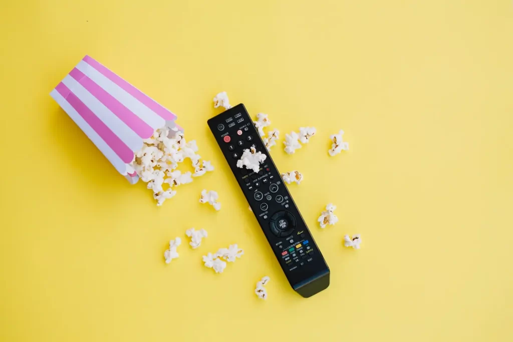 TV remote and popcorn – IPTV entertainment setup in UK and Europe