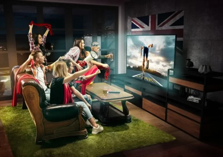A group of enthusiastic friends watching a sports match on television in a British-themed living room, symbolizing British IPTV services